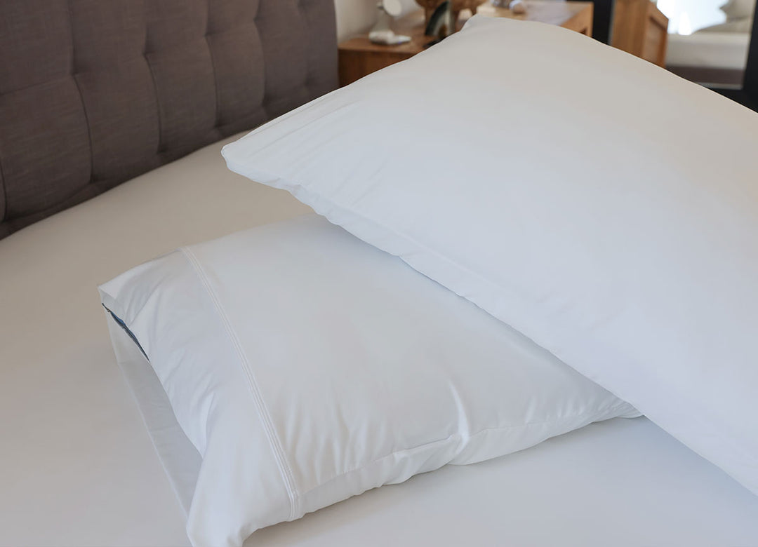 Bright White pillowcase pair shown on bed. #choose-your-color_bright-white