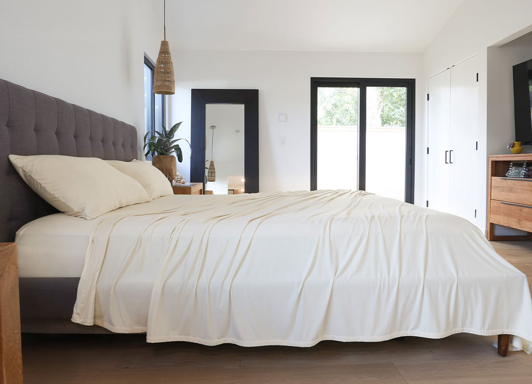 Ecru sheet set shown on bed in bedroom environment. #choose-your-color_ecru