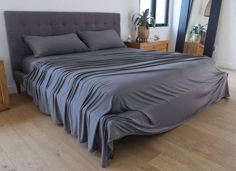 Graphite sheet set shown on bed in bedroom environment. #choose-your-color_graphite