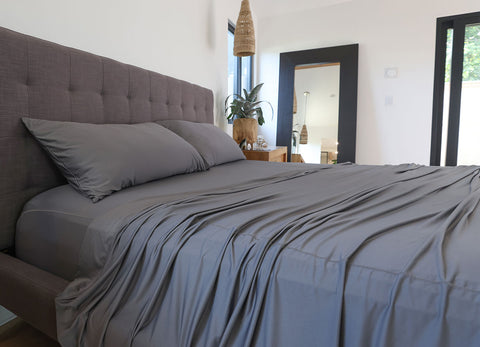 Graphite sheet set shown on bed in bedroom environment. #choose-your-color_graphite