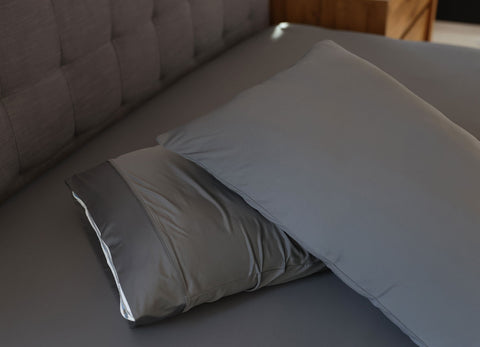 Graphite pillowcase set shown on bed in bedroom environment. #choose-your-color_graphite