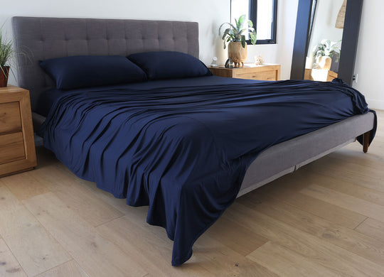 Navy Blue sheet set shown on bed in bedroom environment. #choose-your-color_navy