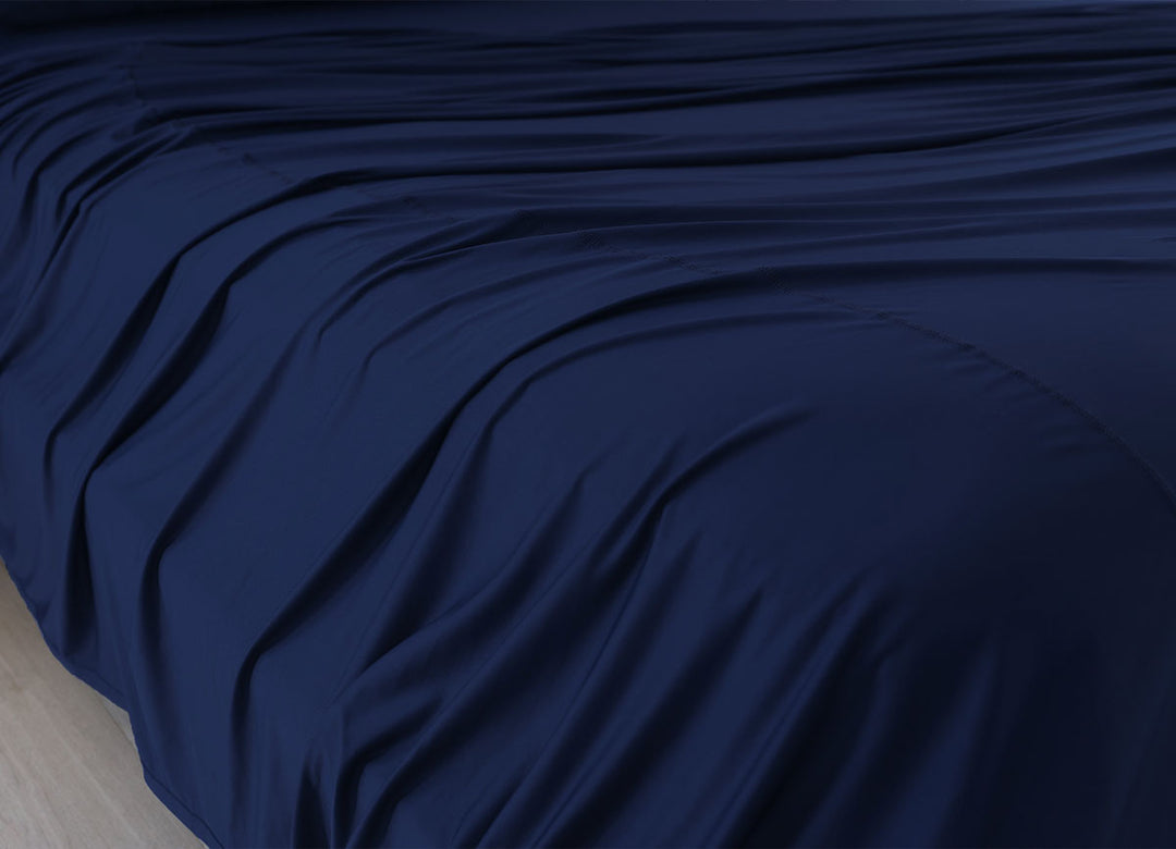 Navy Blue sheet set shown on bed in bedroom environment. #choose-your-color_navy