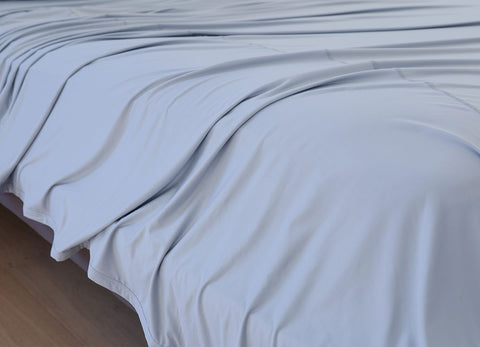 Pearl Blue sheet set shown on bed in bedroom environment. #choose-your-color_pearl-blue